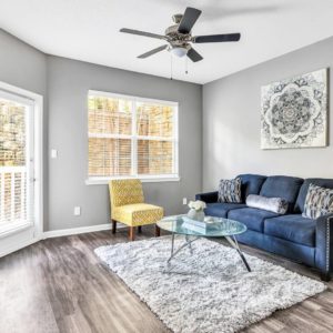 Airbnb Living Room with Blue Couch and Wooden Floors