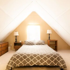 Airbnb Bedroom Under Slanted Roof with Two Nightstands
