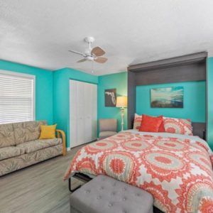 Fort-Myers-Beach-Florida-Airbnb-Option-6-Bedroom with Grey Couch and Yellow Accent PIllows