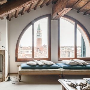 Airbnb Living Room with huge window on Saint Marks Square and view of the Bell Tower, sofas and fireplace