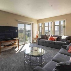 Airbnb Living Room with 2 Couches and Floor to Ceiling Windows